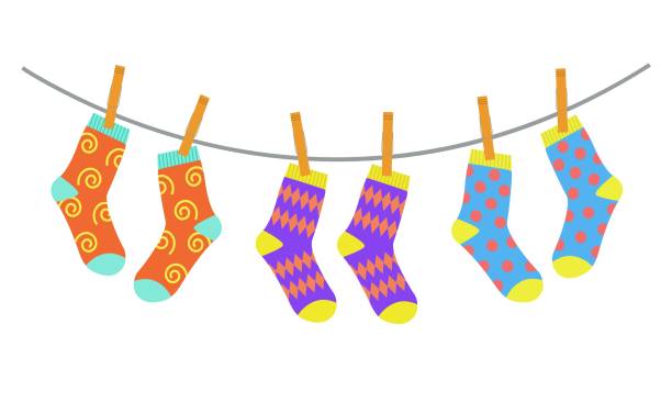 drei paar socken trocknen an der wäscheleine - laundry clothing clothesline hanging stock-grafiken, -clipart, -cartoons und -symbole