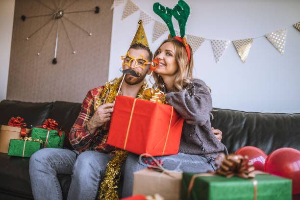 istock Couple celebrating Christmas at home and having  fun 1282375602