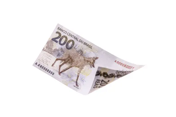 two hundred reais bill falling on isolated background, new Brazilian banknote. Wealth, draw and profit concept