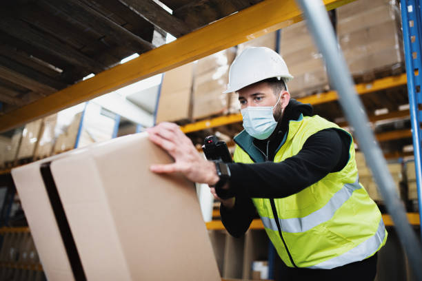 istock Man worker working indoors in warehouse, coronavirus concept. 1282377902