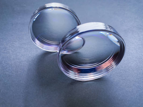 optical plastic lenses for the correction of high myopia with anti-reflective coating.  round blanks of lenses on a dark background.  optics.  vision correction.