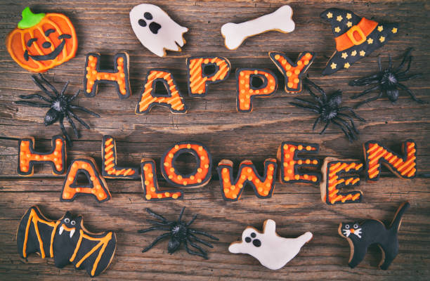 istock Happy Halloween with gingerbread handmade cookies on rustic wooden table 1282379062