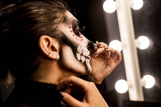 istock Face painting for Halloween night party looking at mirror getting ready looking at camera smiling 1282379885