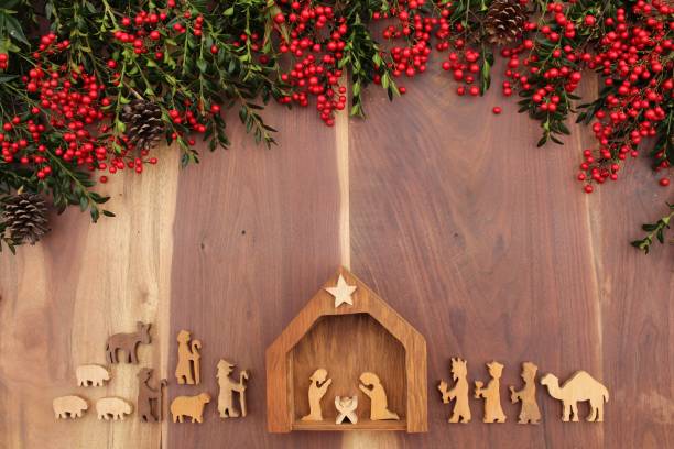 istock christmas nativity on a wood background with red berries and greenery 1282379947