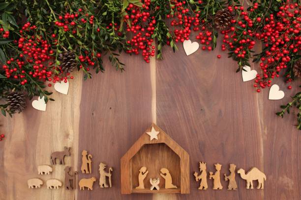istock christmas nativity on a wood background with red berries and greenery 1282379951