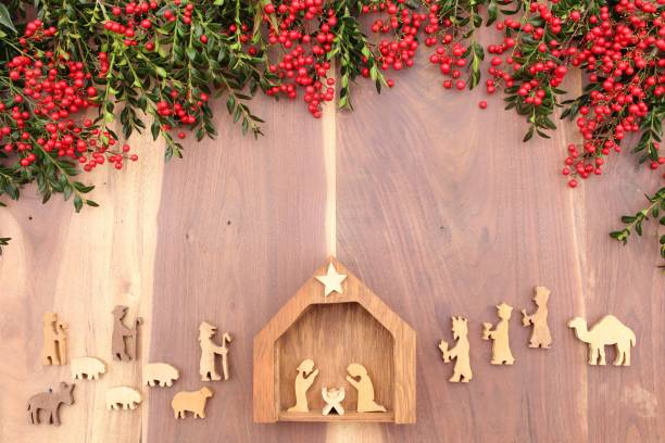 istock christmas nativity on a wood background with red berries and greenery 1282379953