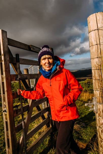 istock Woman passing through a country gate 1282385481