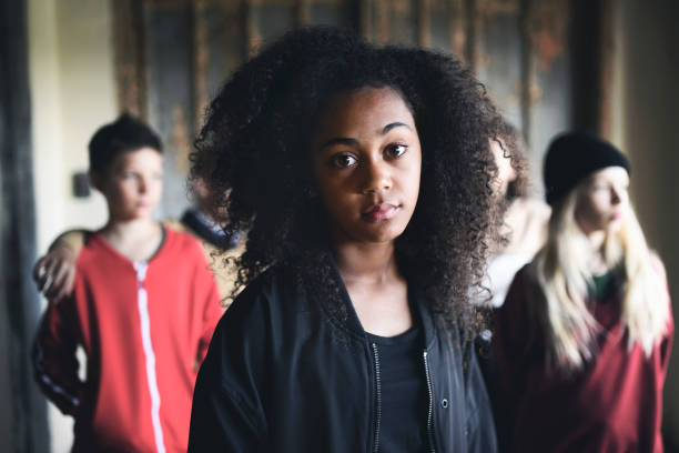 放棄された建物の屋内に立っている友人と混血のティーンエイジャーの女の子の肖像画。 - youth culture gang member adolescence family ストックフォトと画像