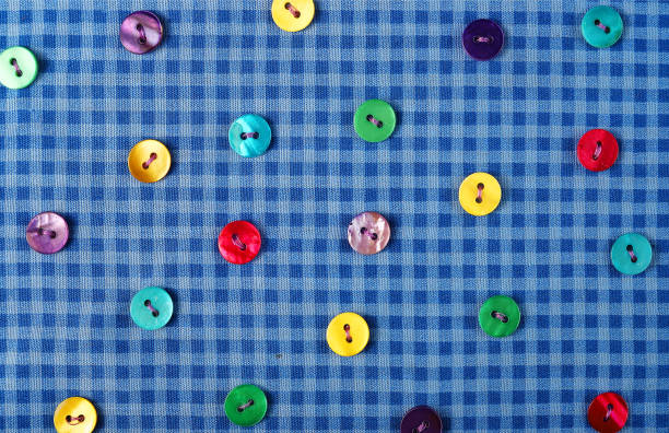 istock Background of blue checkered fabric with buttons. 1282386432