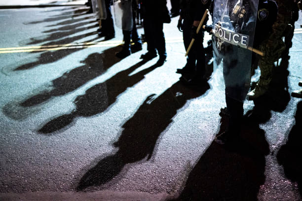 Police shields and shadows at activist protest Police shields and shadows at activist protest protestor photos stock pictures, royalty-free photos & images