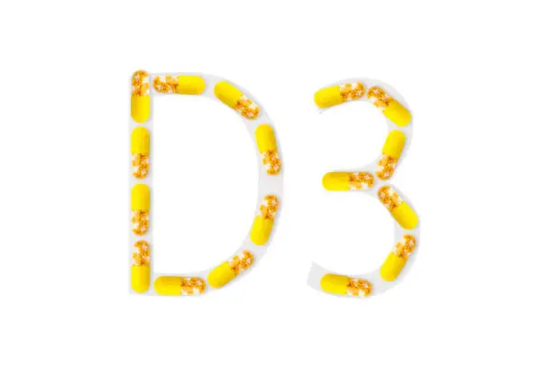 Bright yellow capsules forming shape D3 on white background, Vitamin D3 dietary supplement