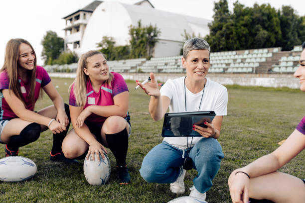 istock Female rugby coach making a play strategy with the team 1282395305