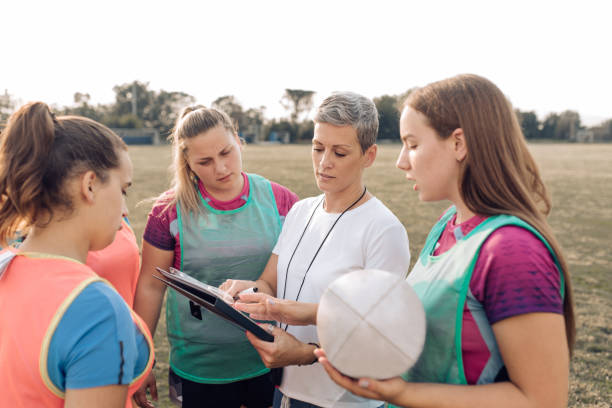 istock Girls from a rugby team working on a play strategy with their coach 1282395317