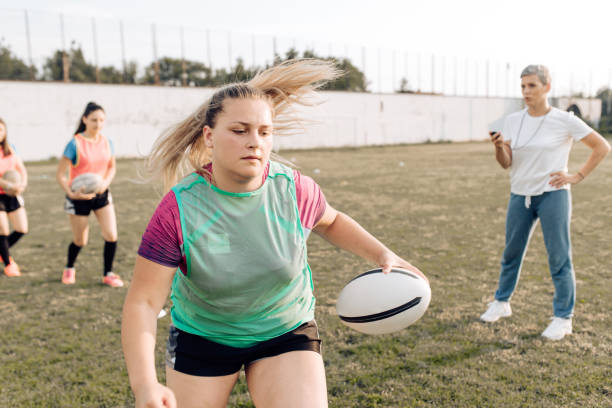 istock Girls from a rugby team training with their coach 1282395321