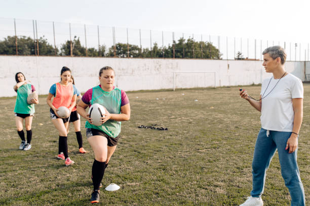 istock Female rugby coach working with her team on the training 1282395325