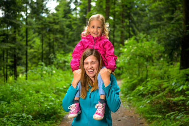 istock Happy smiling mum with her daughter on walk in forest. 1282395485