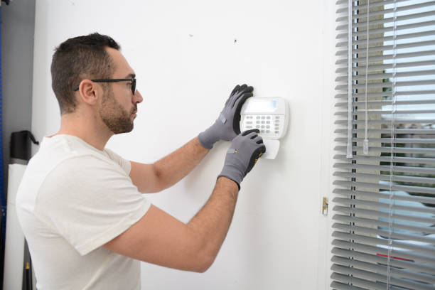 istock handsome man worker installing alarm technology insurance in home for burglar prevention 1282396038
