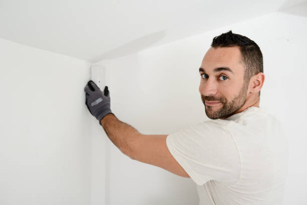 istock handsome man worker installing alarm technology insurance in home for burglar prevention 1282396057