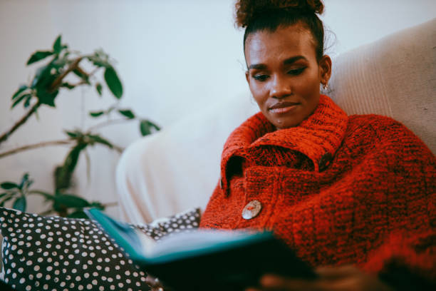 istock Woman relaxing at home, reading a book 1282396780
