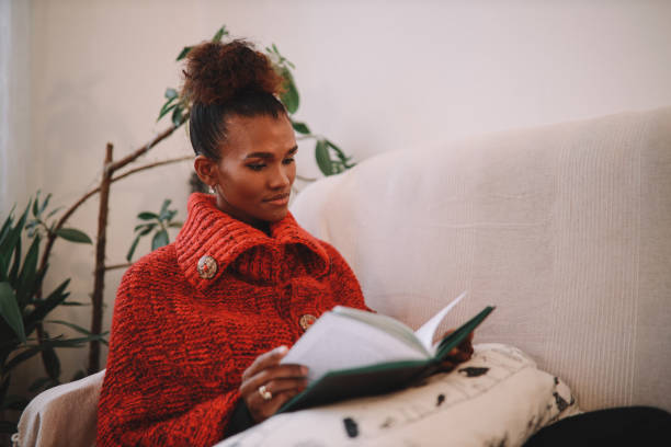 istock Woman relaxing at home, reading a book 1282396799