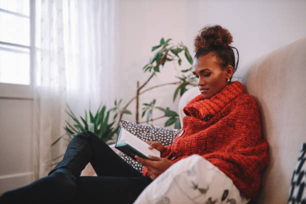 istock Woman relaxing at home, reading a book 1282396815