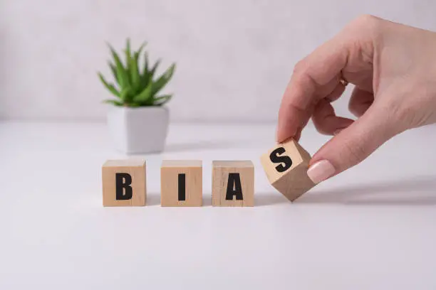 Bias - word from wooden blocks with letters, personal opinions prejudice bias concept, white background.