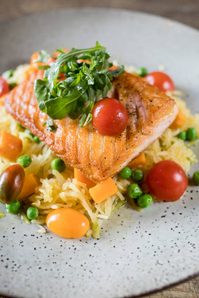 Grilled Salmon served over rice with tomatoes