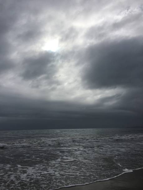 istock Light breaks through a stormy sky over the beach 1282403699
