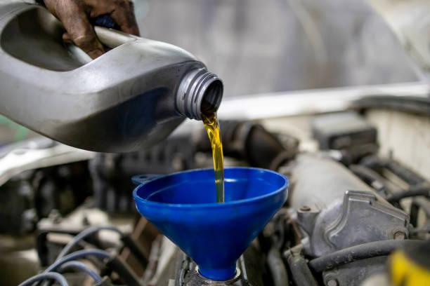 istock technician worker pouring engine oil. car maintenance at service station or workshop. selective focus 1282403808