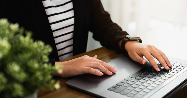 istock Hand using digital laptop on the table in office and wear smartwatches. 1282406465