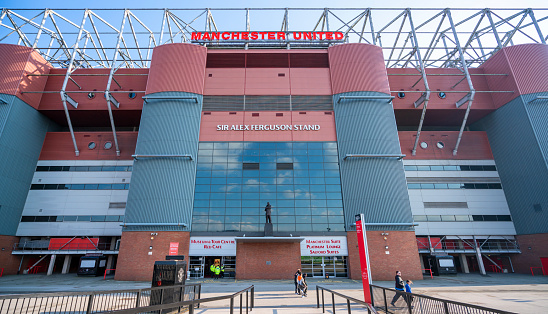 Elegant bronze statue of Sir Alex Ferguson in front of d of Old Trafford football stadium, Old Trafford is the largest stadium home of Manchester united football club.