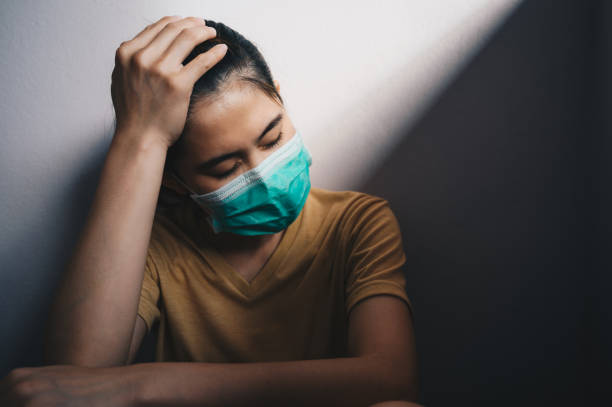 istock Depressed woman having headache after failure and layoff from work because impact from covid-19 pandemic outbreak. 1282408281