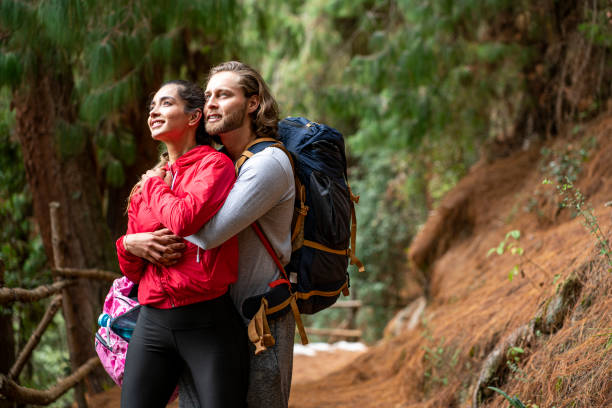 istock wedding couple walks through the woods and embraces 1282409095