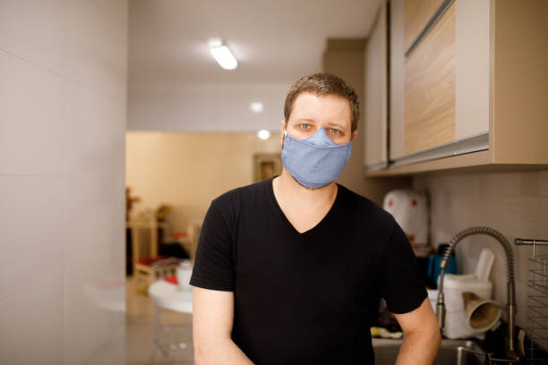 istock Blond man wearing mask on kitchen portrait 1282410895