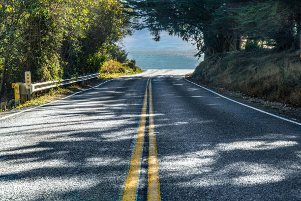 istock Driving off a cliff into the ocean from a road 1282414043