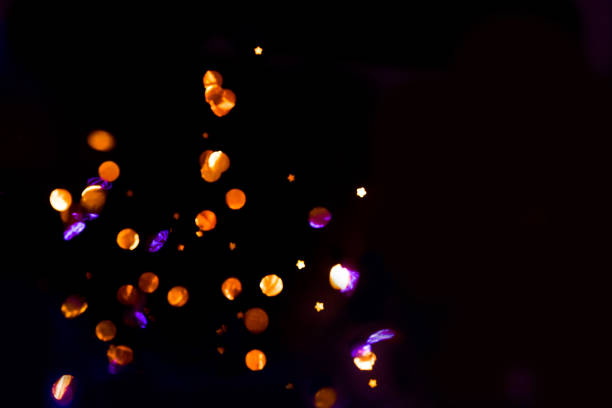istock Abstract background, overlay of sparkling confetti in motion on black background 1282416902