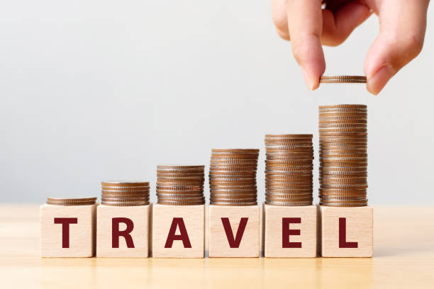 istock Hand putting coins on stack stair as step growing growth and wooden cube block with word TRAVEL. Investment and save money concept 1282417761