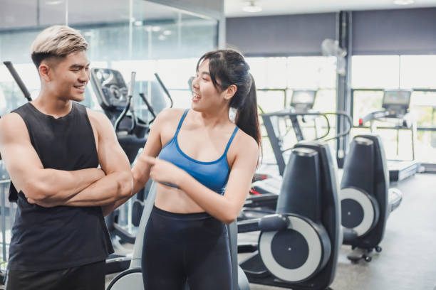 istock Asian couples posting post a photo with camera so exercise before running on the treadmill.Athletic exercises.Metaphor Fitness and workout concept exercise Health lifestyle muscle body of your health 1282417888