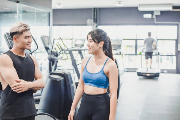 istock Asian couples posting post a photo with camera so exercise before running on the treadmill.Athletic exercises.Metaphor Fitness and workout concept exercise Health lifestyle muscle body of your health 1282417896
