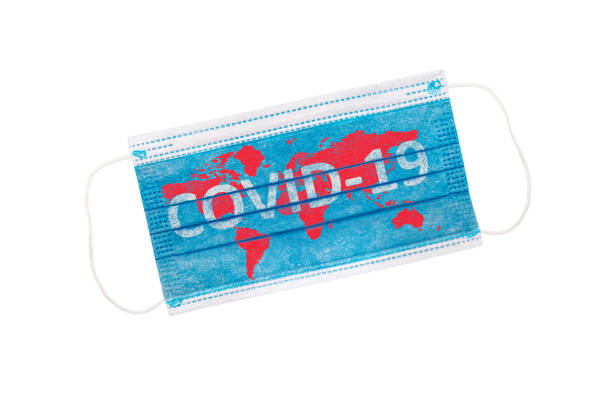 istock Protective face mask isolated on white background with world map and inscription COVID-19. Coronavirus outbreak around the world 1282422114