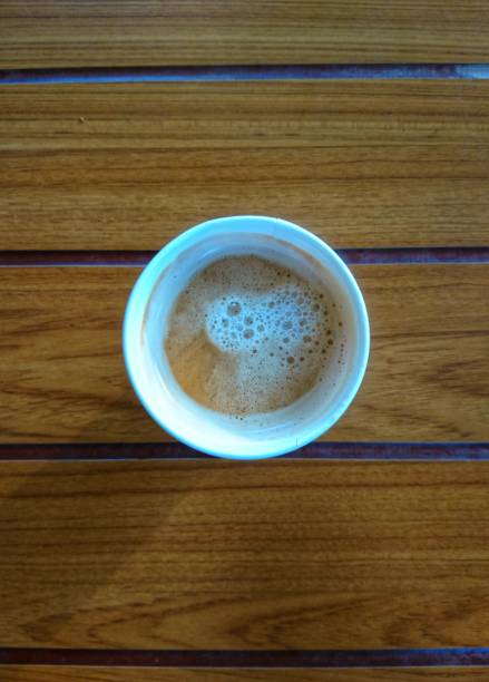 istock Paper cup of coffee on a wooden table. 1282422805