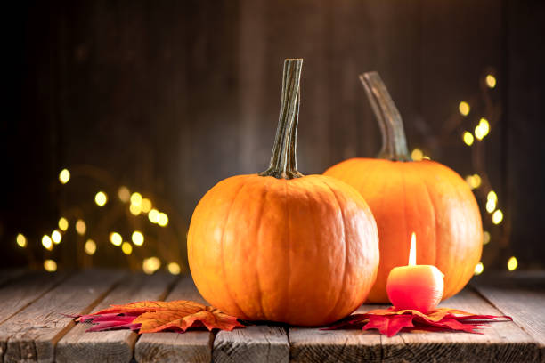 istock Thanksgiving decoration with pumpkins and greeting card on illuminated background and a rustic wooden table 1282422933