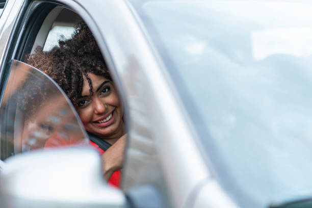 istock Portrait of Woman mobilizing in a vehicle that she requested through a mobile application a prevention for the COVID19 pandemic 1282424002