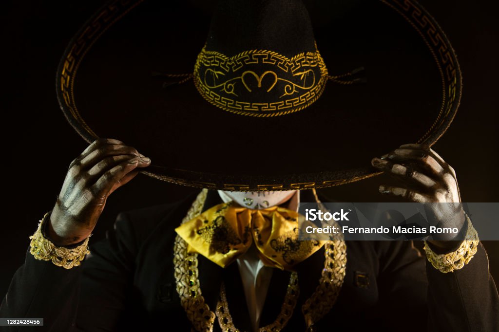 mexican charro holding his hat Mariachi Stock Photo