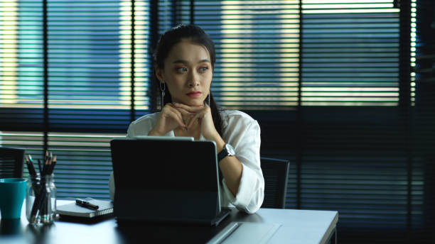 istock Female office worker thinking about her work while sitting in office room 1282428712