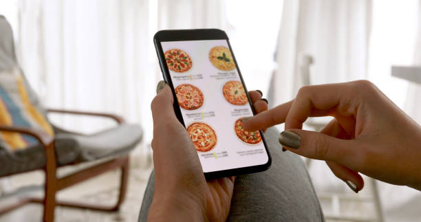 istock Woman ordering pizza at home online 1282428722