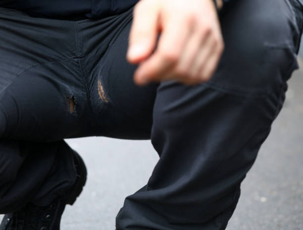 Man in squatting position with holes at pants Man in squatting position with holes at pants close-up hole in pants stock pictures, royalty-free photos & images