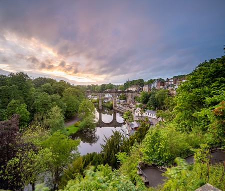 classic view of the railway viaduct architecture crossing the river Nidd in the market town of Knaresborough North Yorkshire England