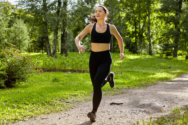 istock Young woman is runnning in public park. 1282432443
