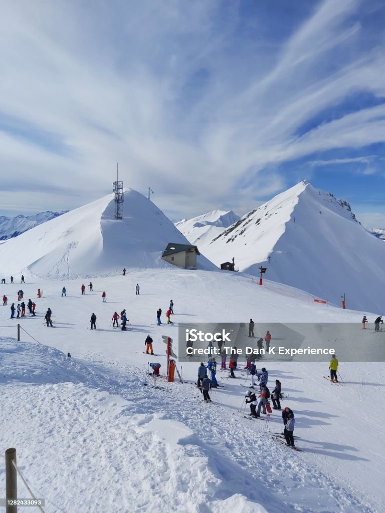 Scatter A group of skiers looking for Directions atop a ski slope at La Plagne 1800, France La Plagne Stock Photo